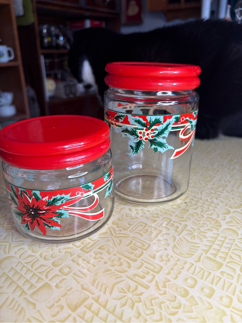 Vintage Holiday Glass Storage Jars with Red Lids and Festive Poinsettia Design